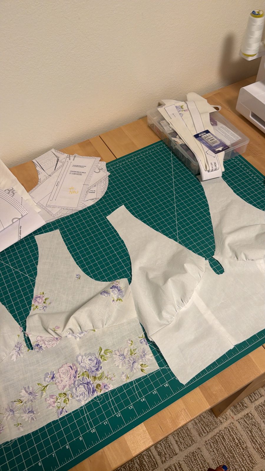 Margot bodice pieces cut from the sheet on the cutting mat, with the floral cuff used for the waistband